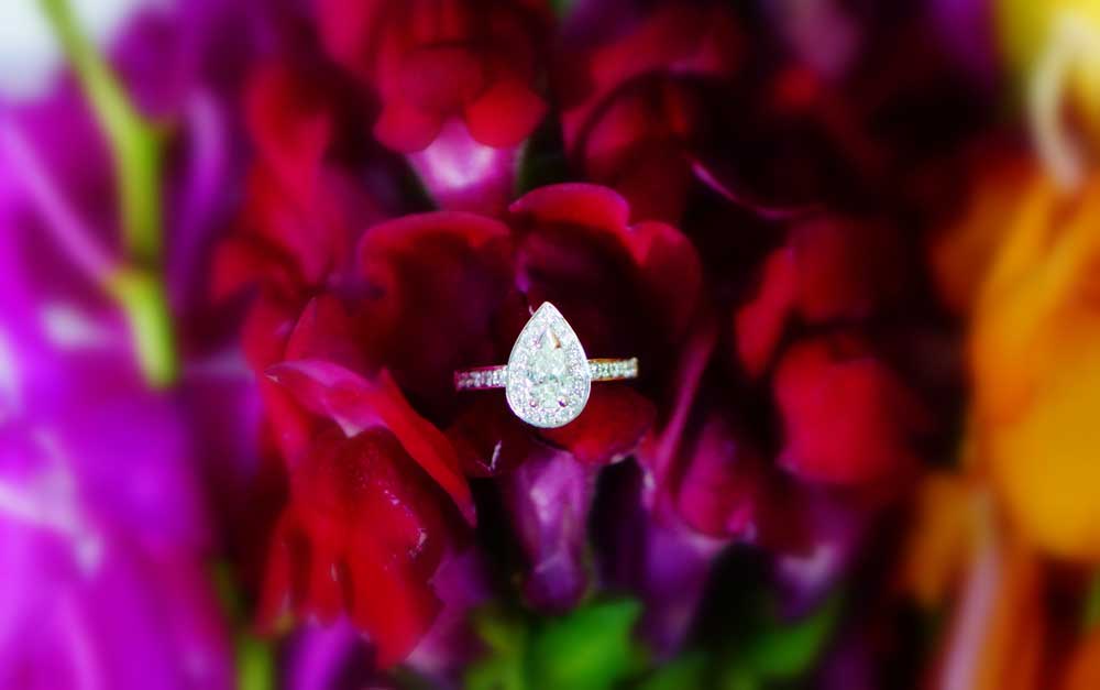 A stunning pear diamond with halo and diamond shoulder | unique engagement ring | Diamondport