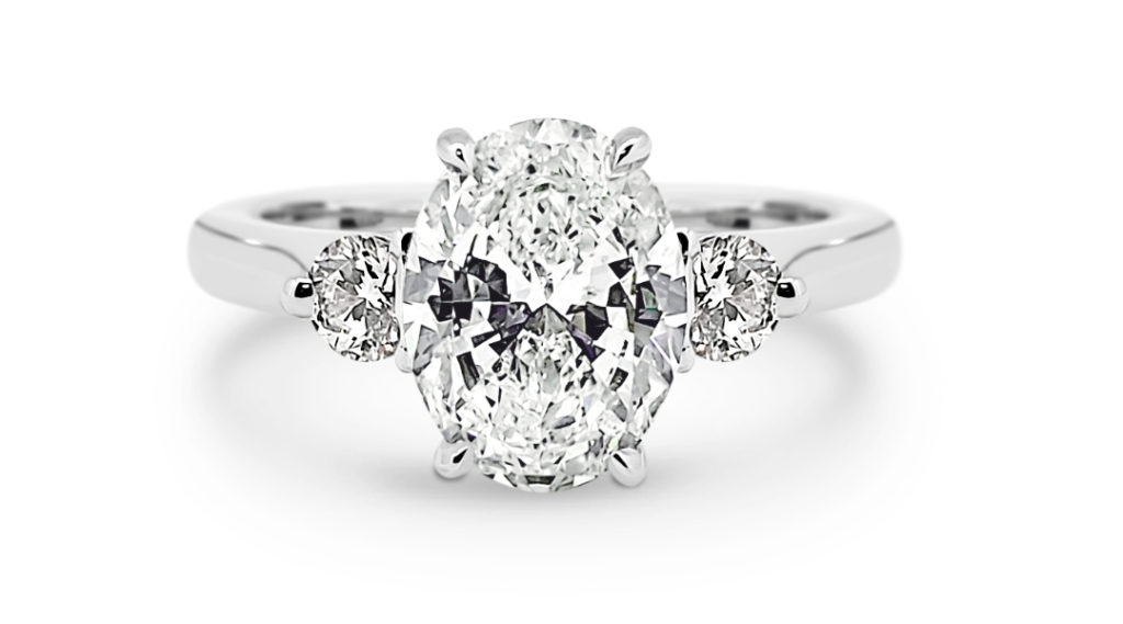 Three stone engagement ring with an oval diamond and pear diamonds