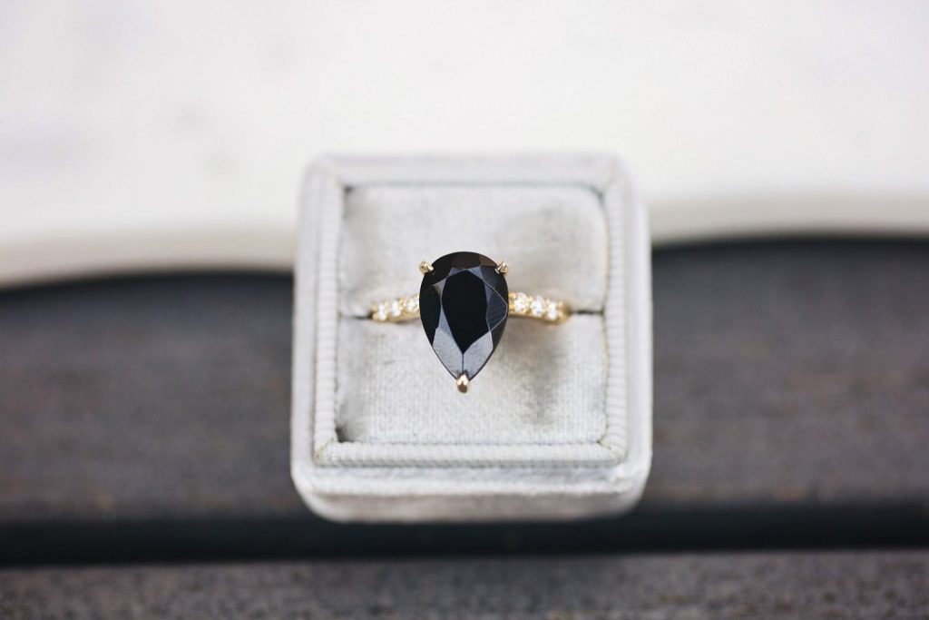 Gay marriage rings with pear-shaped black diamond and gold band