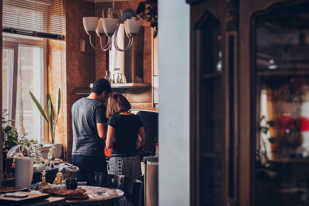 Relaxed couple cooking together in a cosy kitchen