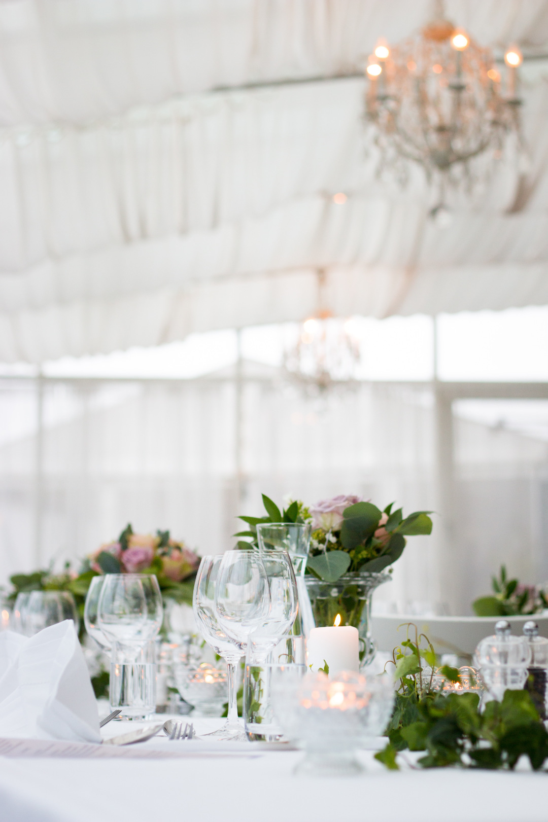 Wedding table setup with candles and glasses