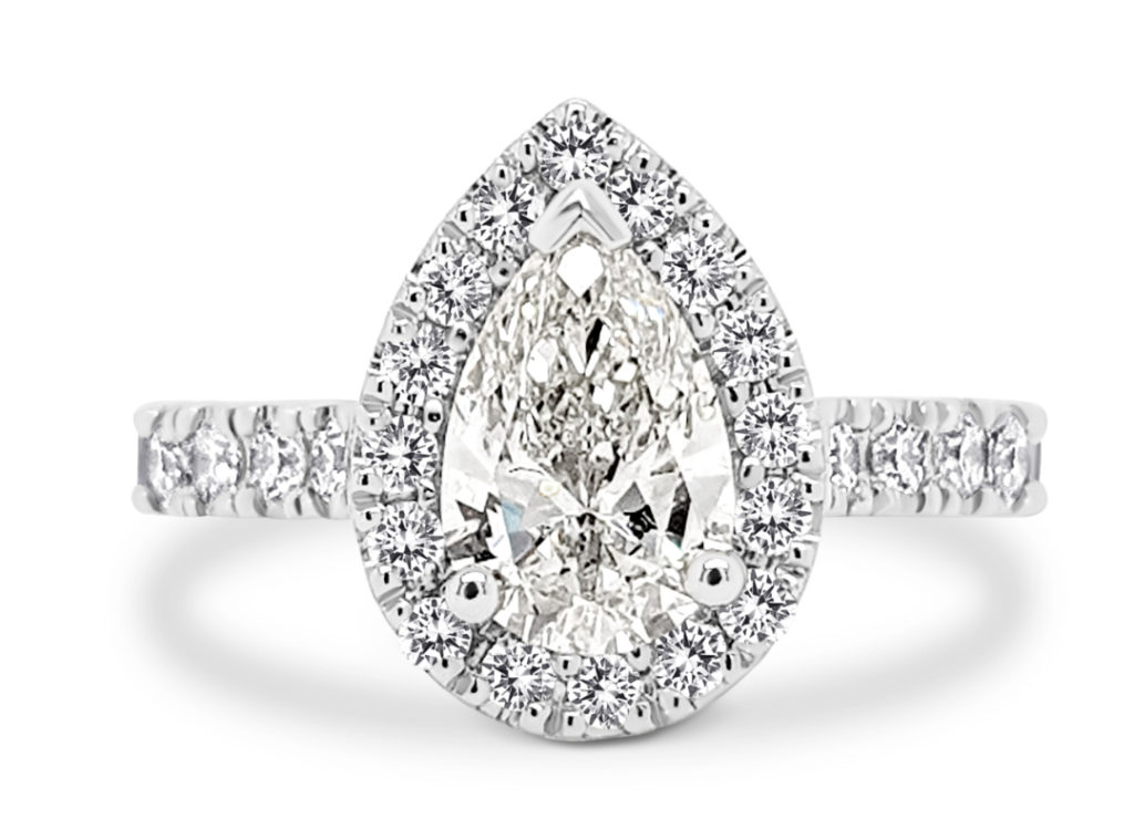 Engagement ring with pear cut diamond and diamond halo