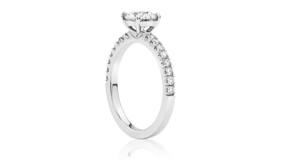 Round brilliant diamond engagement ring with split claw diamond band side view