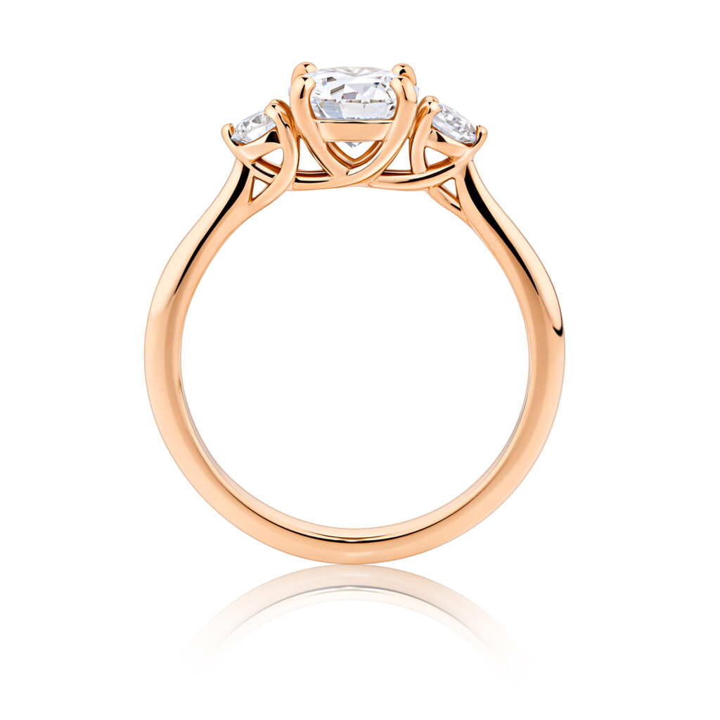 Frangipani-round-cut-rose-gold-trilogy-diamond-engagement-ring-side-view